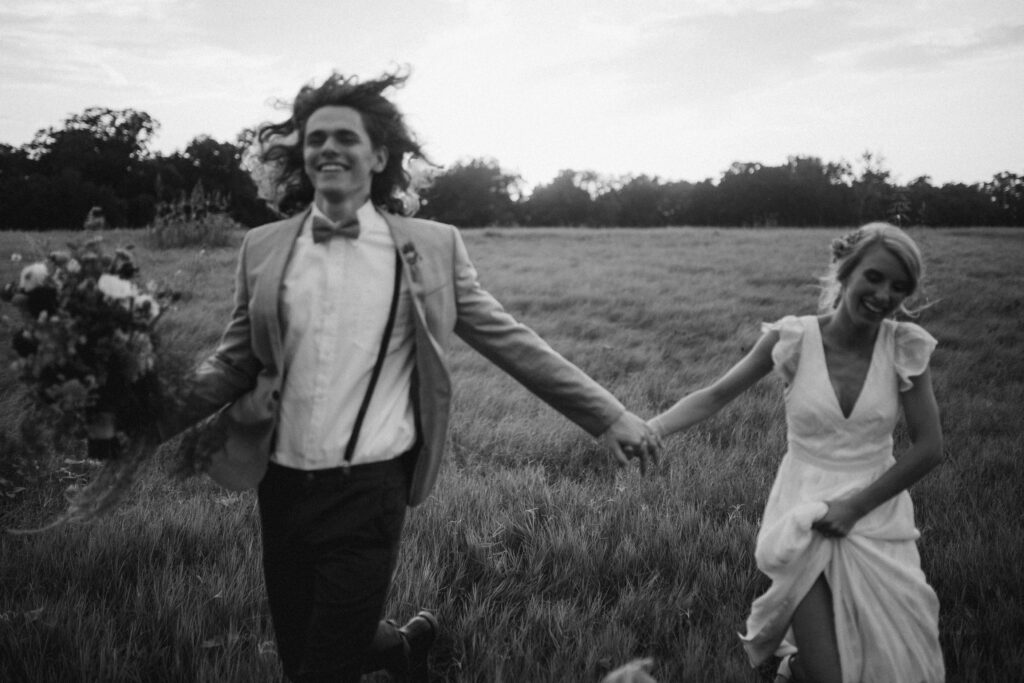 bride-and-groom-running-through-a-meadow