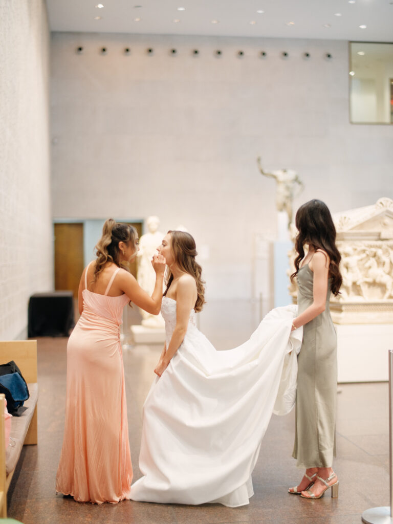 A bride with her bridesmaids getting ready at MFAH