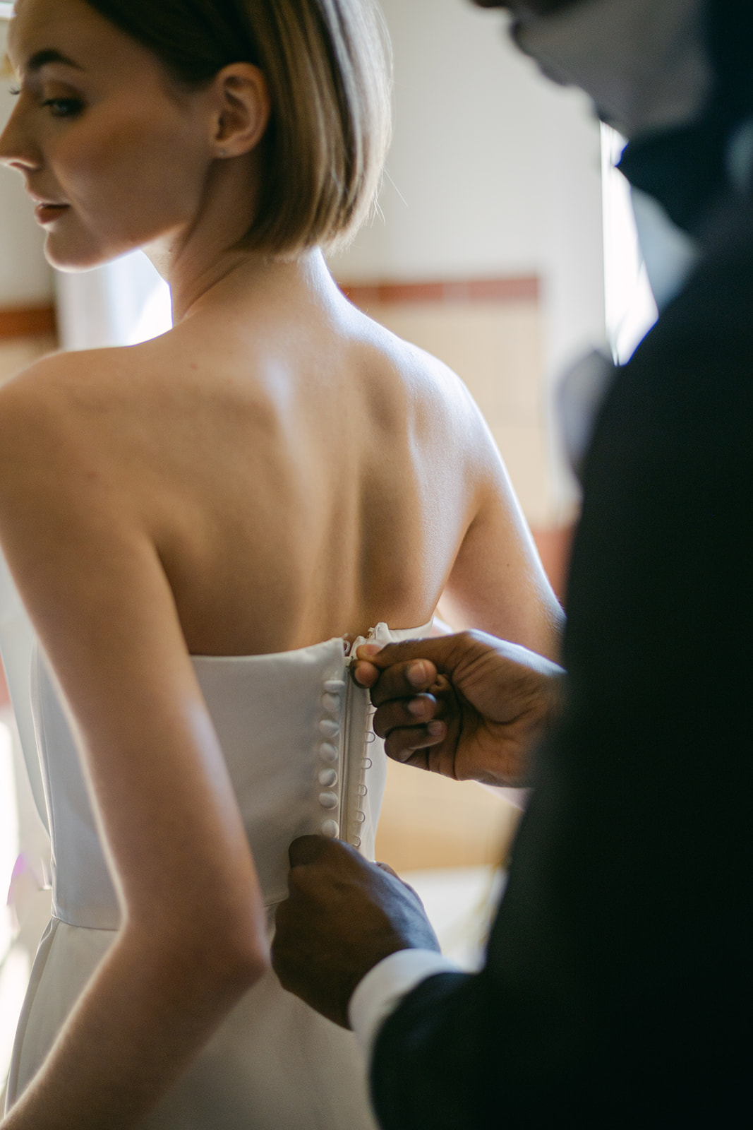 Bride and groom getting ready together on the wedding day