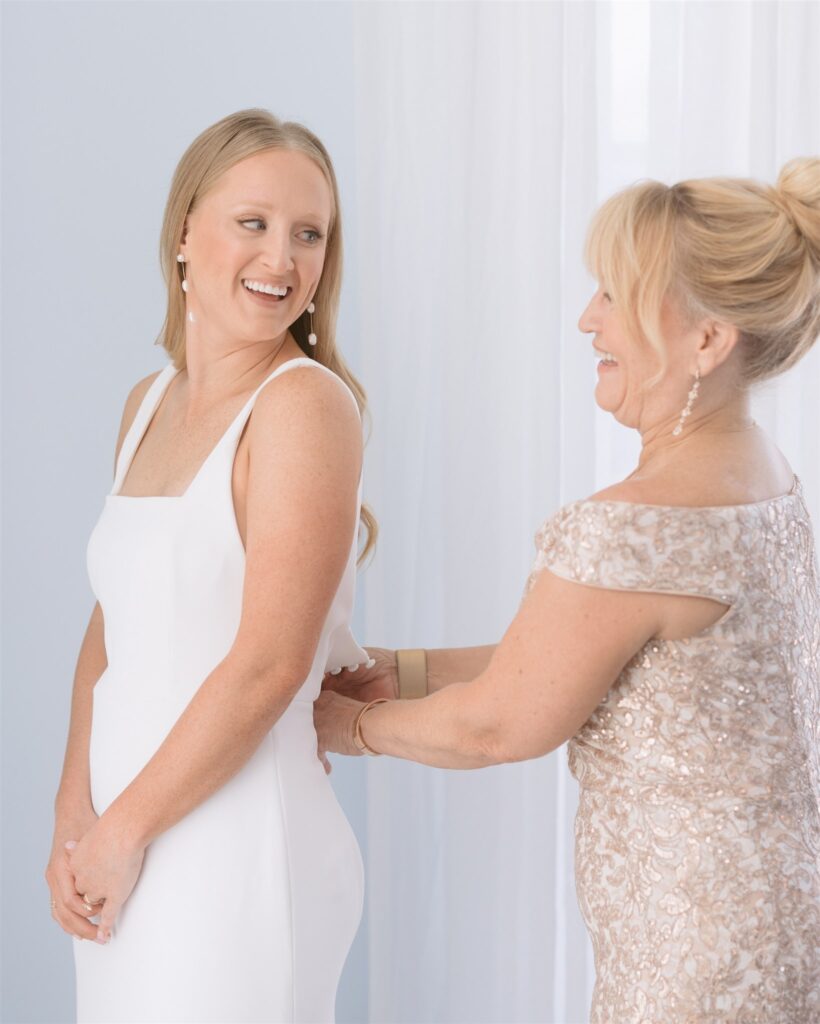 bride and her mother getting dressed t hotel galvez