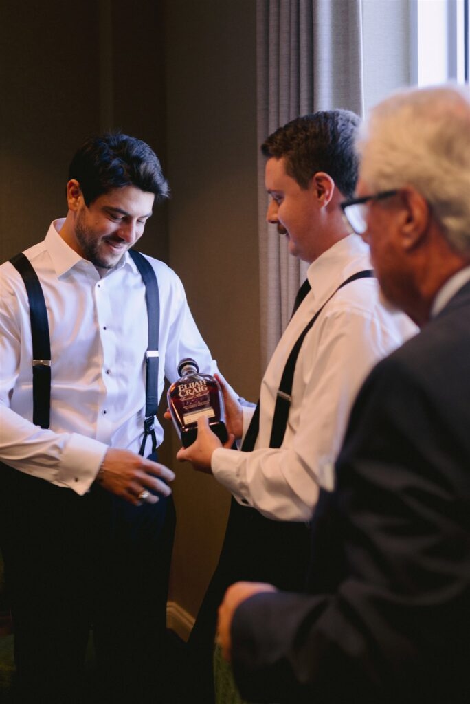 groom and groomsman getting ready before wedding