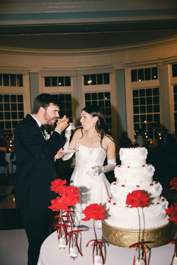 bride and groom eating cake at galveston wedding