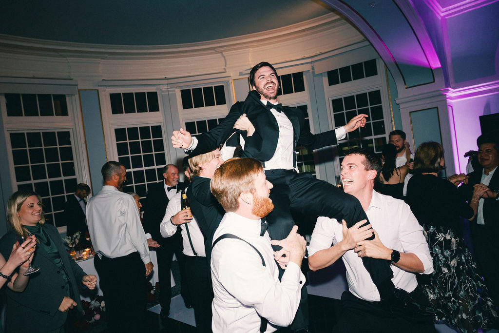 groom being listed on the dance floor at Galveston wedding reception