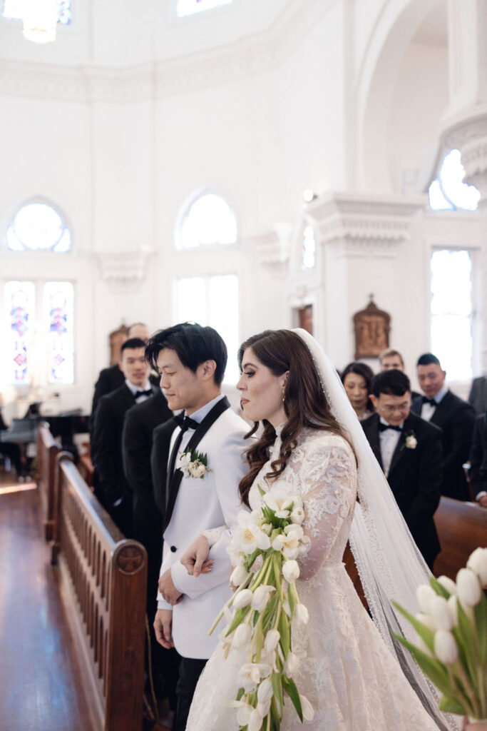 Sacred Heart Catholic Church wedding: Bride and groom walks their way to the altar.