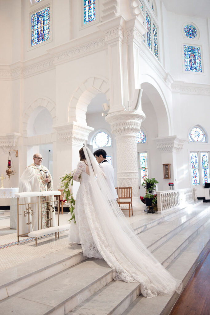 Sacred Heart Catholic Church wedding: Bride and groom walks their way to the altar.