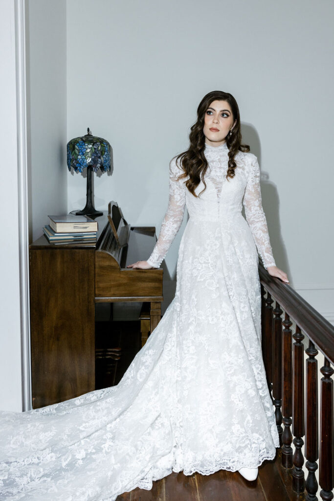 Elegant bridal portrait with the bride leaning on a vintage balustrade at The Bryan Museum