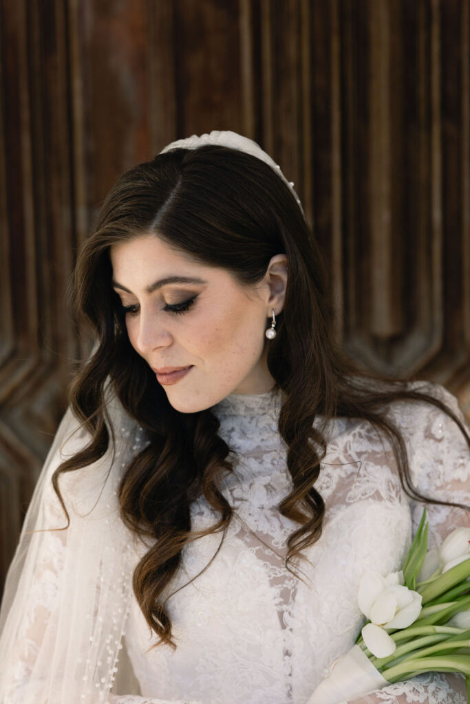 Close-up photo of the bride, captured outside the Sacred Heart Catholic Church, before the Bryan Museum wedding.