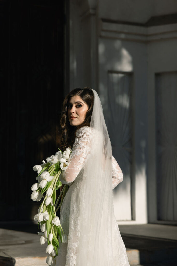 A portrait of the bride captured outside the Sacred Heart Catholic Church, before the Bryan Museum wedding.
