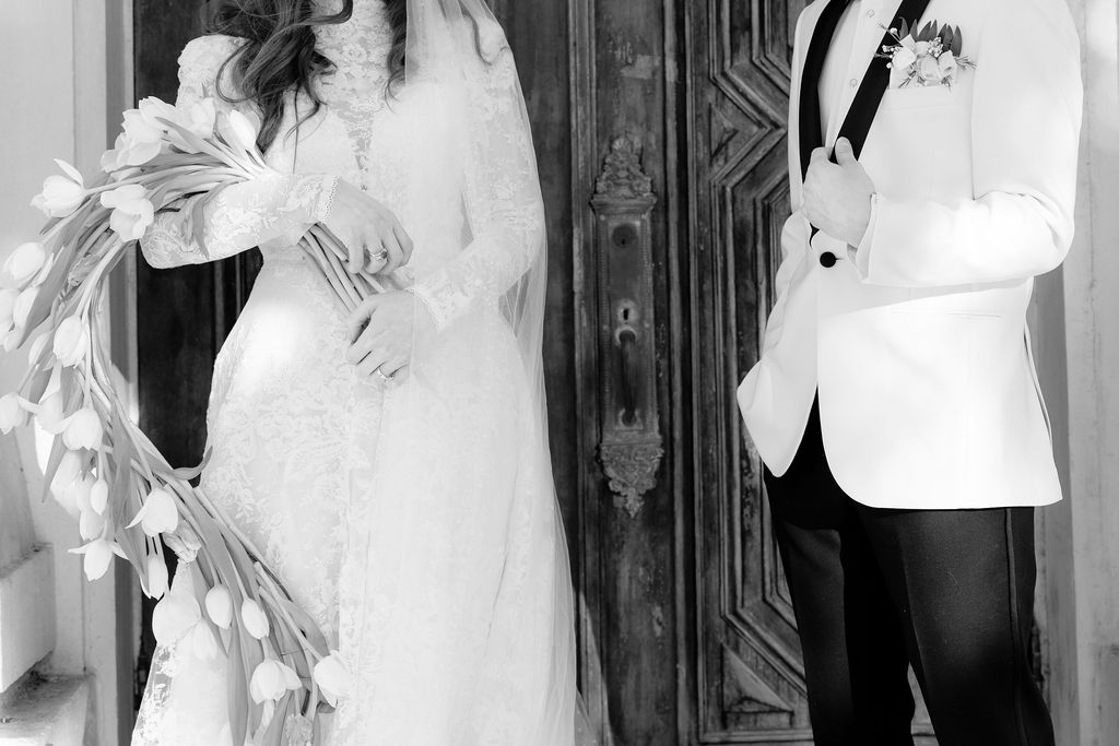 Bride and groom black and white photo, captured outside the Sacred Heart Catholic Church, before the Bryan Museum wedding.