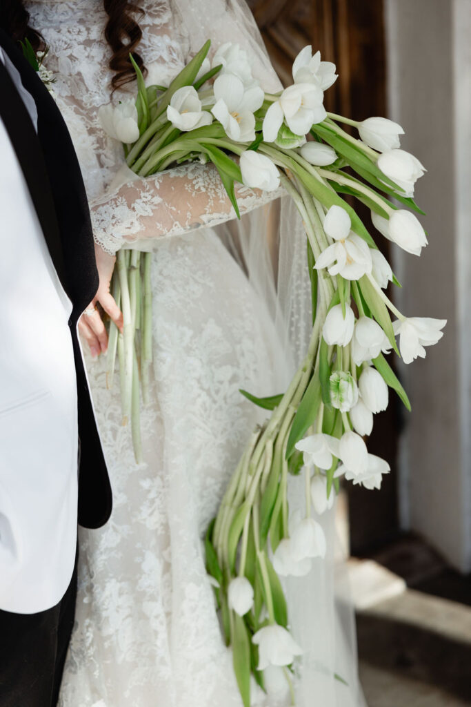 Details of the bride's tulip bouquet, captured outside the Sacred Heart Catholic Church, before the Bryan Museum wedding.