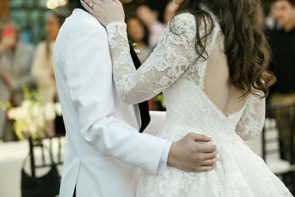 Close-up of bride and groom shares their first dance at the Bryan Museum Conservatory.