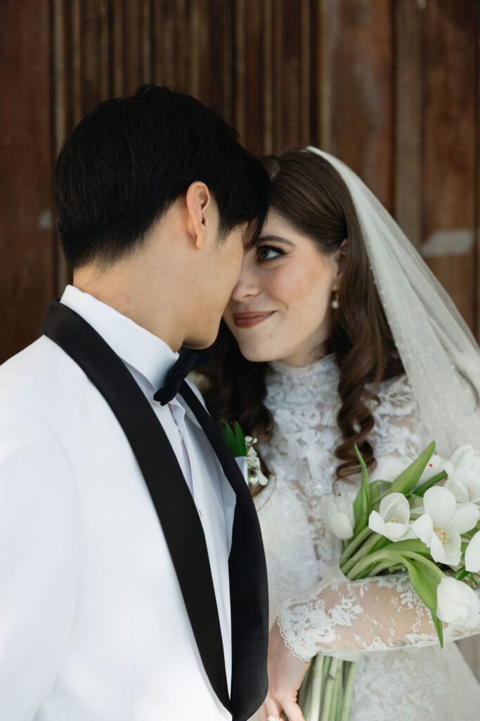 Bride and groom intimate photo, captured outside the Sacred Heart Catholic Church, before the Bryan Museum wedding.
