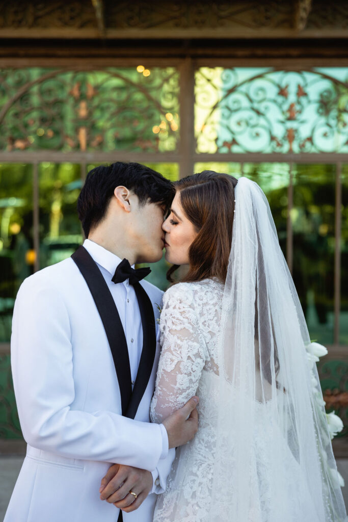 Groom and Bride kissed, captured outside Bryan Museum Conservatory.