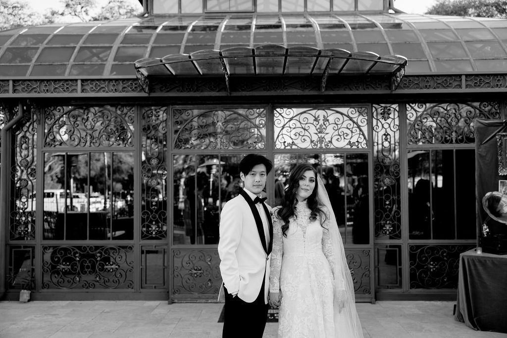 Bride and groom poses for a picture in front of the Bryan Museum in Galveston, Texas.