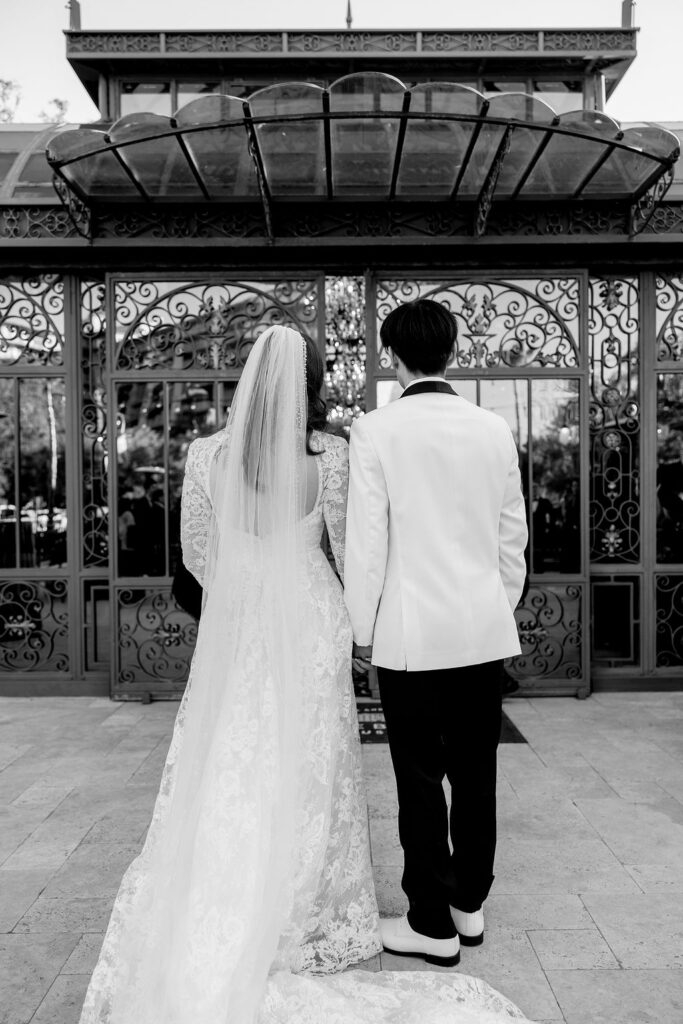 Photo of the bride and groom's back, captured outside Bryan Museum Conservatory.