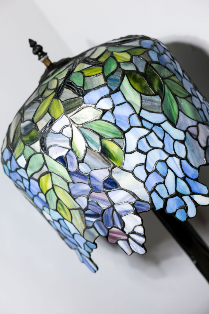 Close-up of decorative lamp with blue and green accents complementing the wedding theme at The Bryan Museum in Galveston, Texas