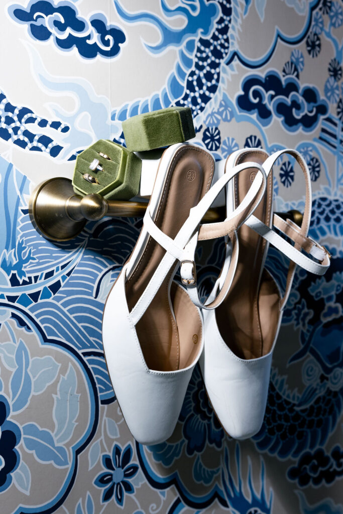 Close-up of bridal shoes and engagement ring during wedding preparations at The Bryan Museum in Galveston, Texas