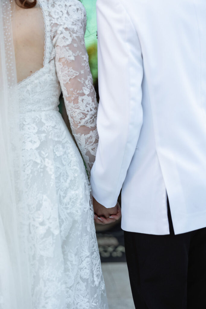 Photo of the bride and groom holding hands, captured outside Bryan Museum Conservatory.