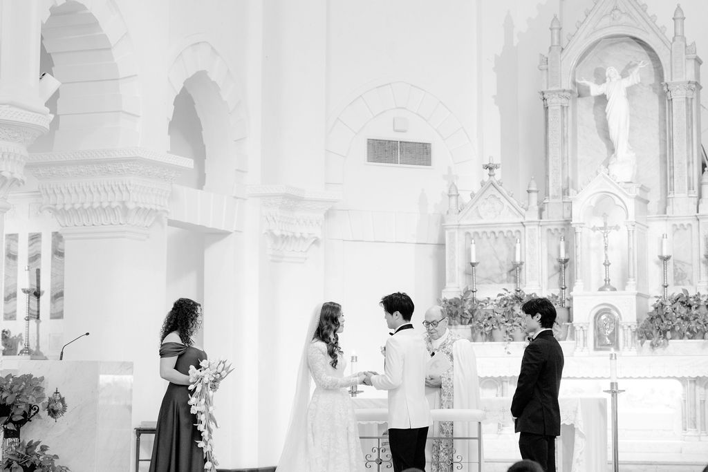 Galveston church wedding: Couple exchanging vows at Sacred Heart Catholic Church.