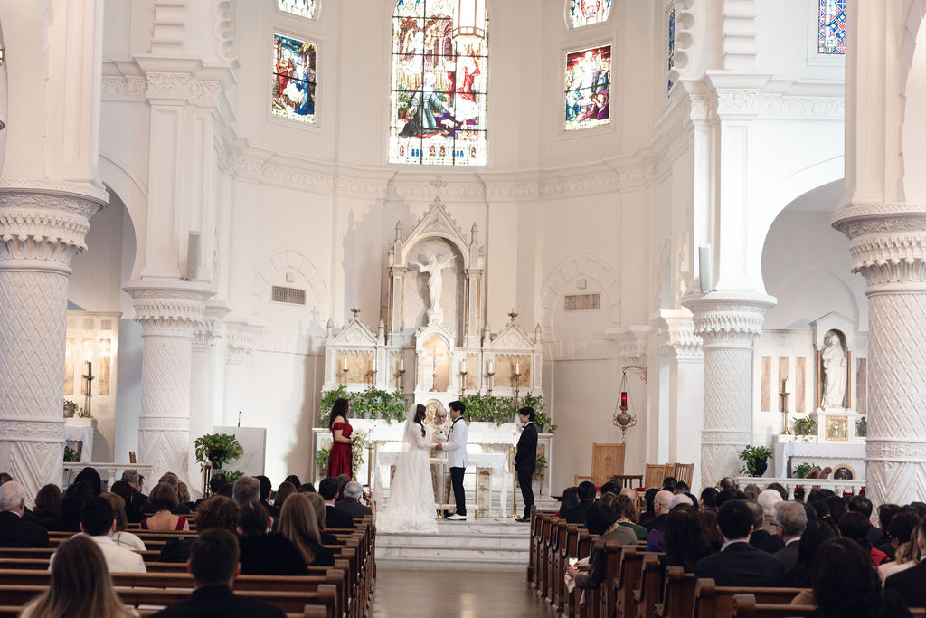 Sacred Heart Catholic Church wedding: Bride, groom, and guests in Galveston.