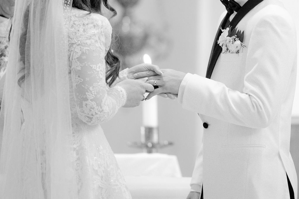 Galveston church wedding: Couple wear rings at Sacred Heart Catholic Church.