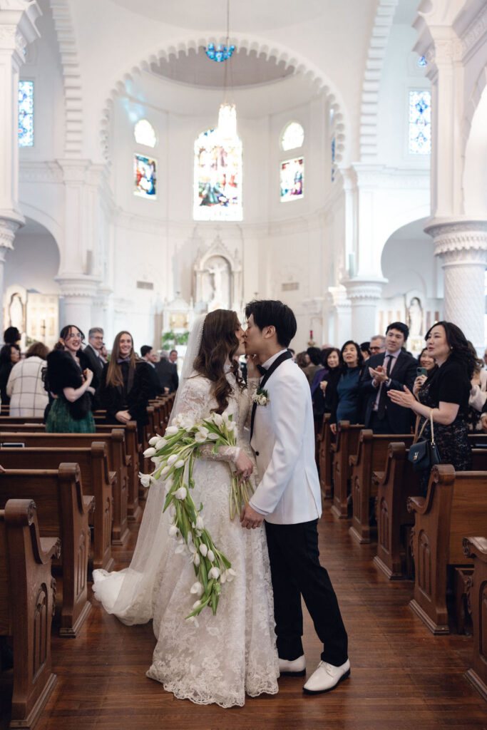 Galveston church wedding kiss: Newlyweds sharing a moment at Sacred Heart Catholic Church