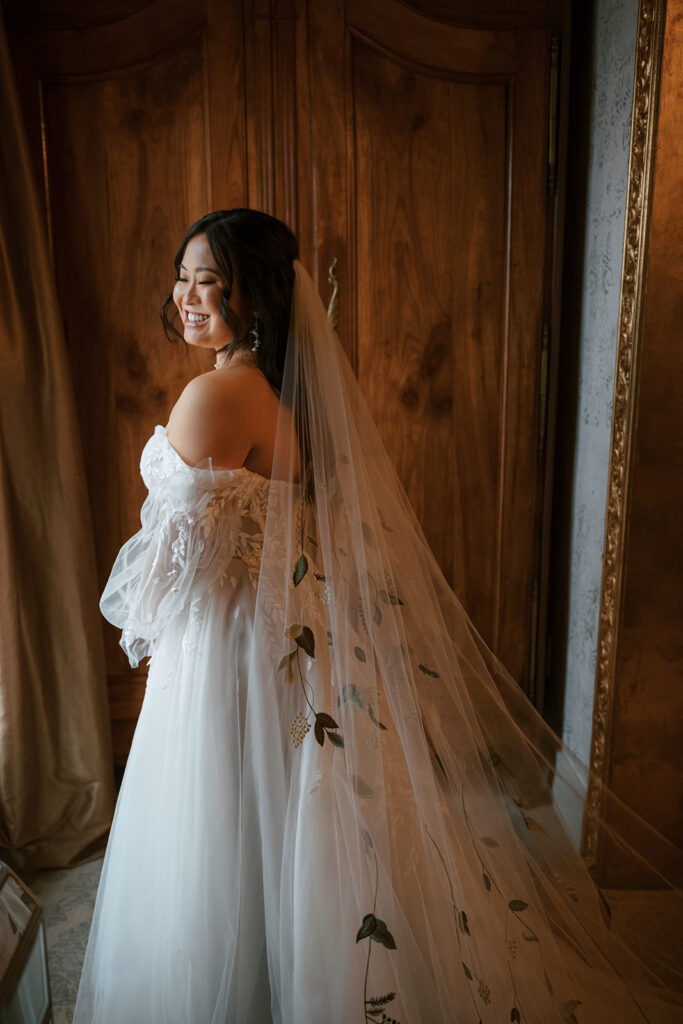 Bride smiles and take a pose for her Bryan Museum garden wedding.