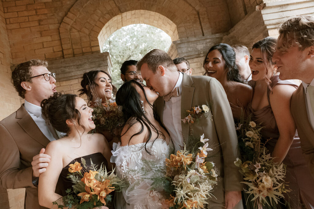 Wedding party takes photos for the Bryan Museum garden wedding