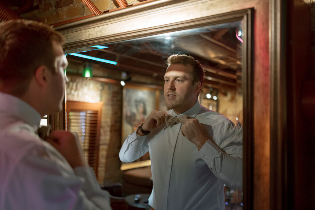 Groom prepares for his Bryan Museum garden wedding.