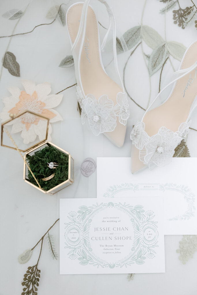 Flatlay photos of Jessie and Cullen's wedding details of their Bryan Museum garden wedding.