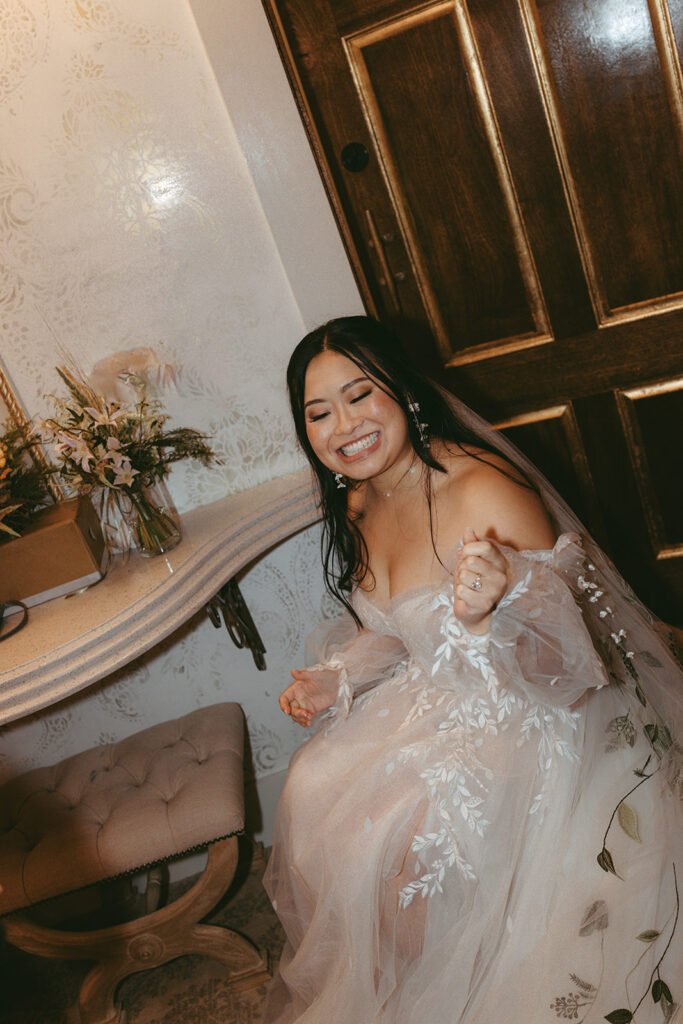 Bride smiles as she prepares for her Bryan Museum garden wedding.