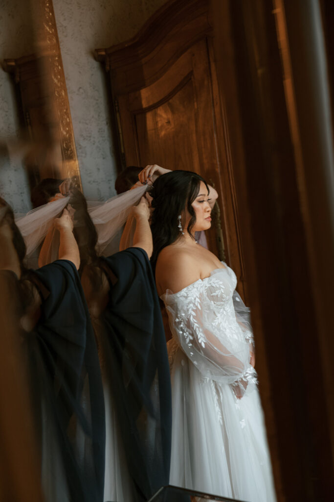 Reflection of the bride as she wore her veil for her Bryan Museum garden wedding.