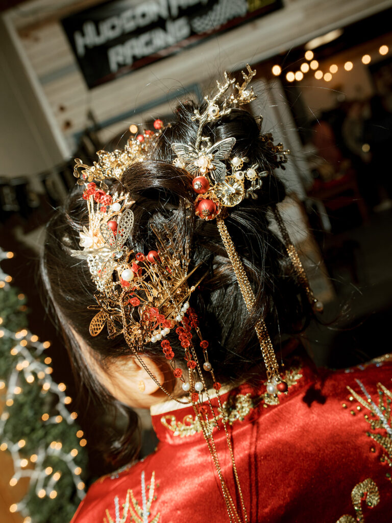 Jessie’s intricate gold headpiece and red gown during the tea ceremony before their Bryan Museum garden wedding