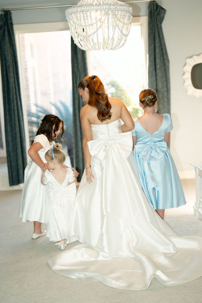Bride takes a photo with her relatives at her Real Wedding at Galveston City National Bank Museum