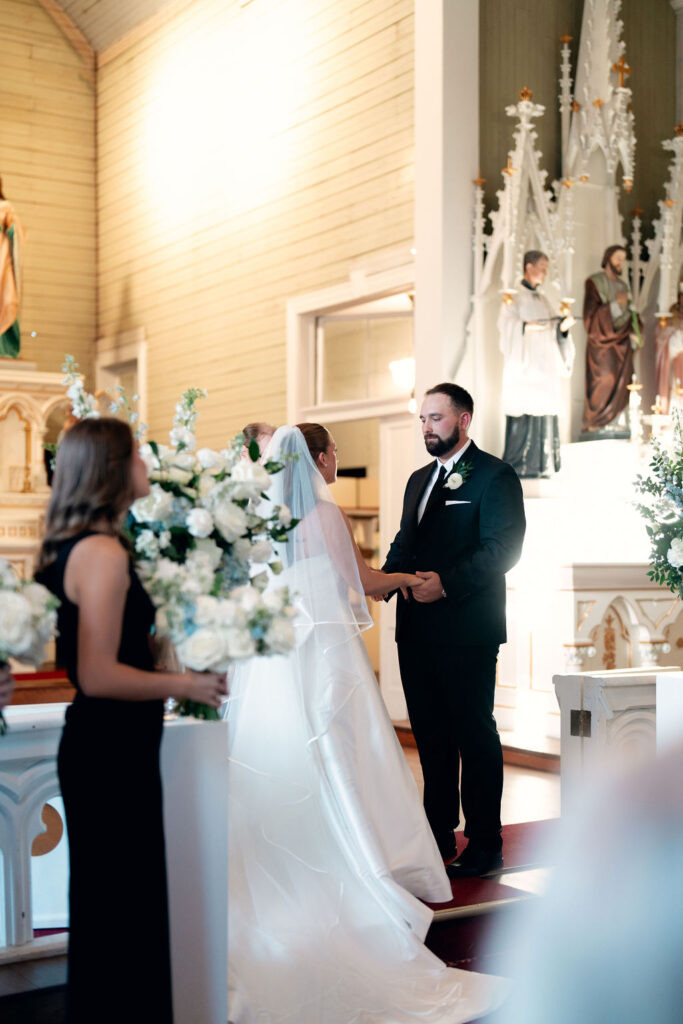 Bride and groom hold hands at their Real Wedding at Galveston City National Bank Museum