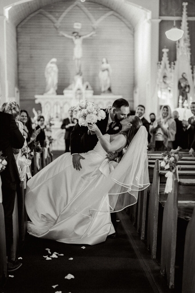 Bride and groom shares a kiss at their Real Wedding at Galveston City National Bank Museum