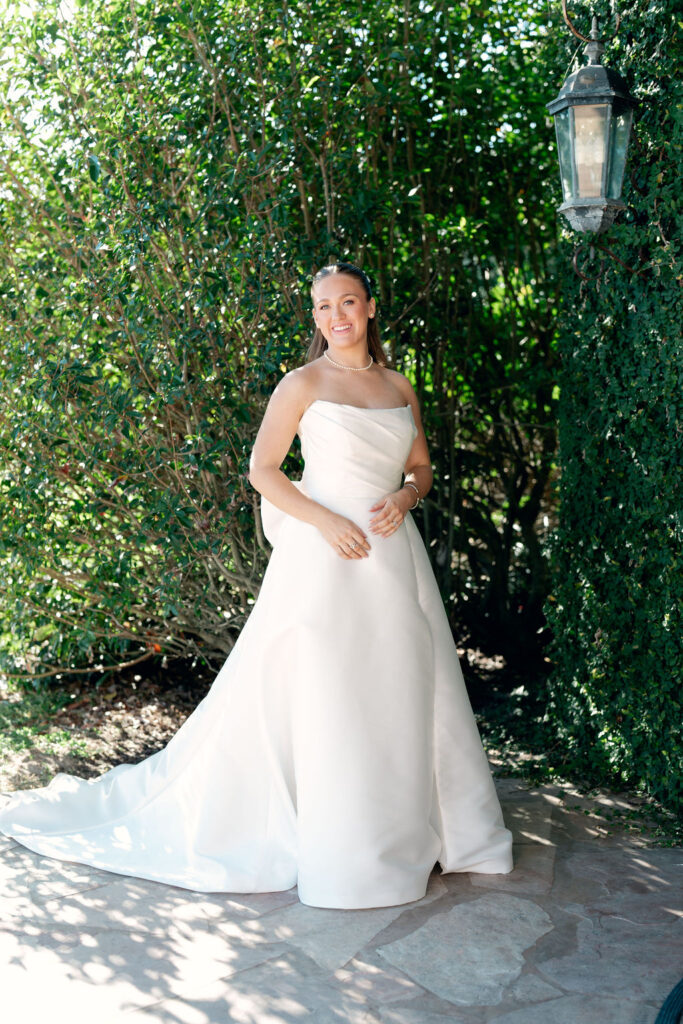 Bride takes a photo before the Real Wedding at Galveston City National Bank Museum