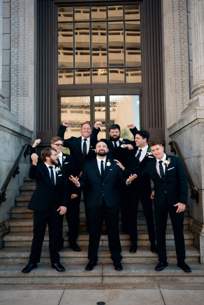 Groom and groomsmen take a candid photo outside before his Real Wedding at Galveston City National Bank Museum