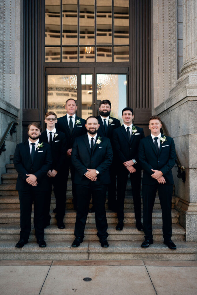 Groom and groomsmen take a photo outside before his Real Wedding at Galveston City National Bank Museum
