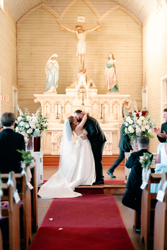 Bride and groom kiss for the Real Wedding at Galveston City National Bank Museum