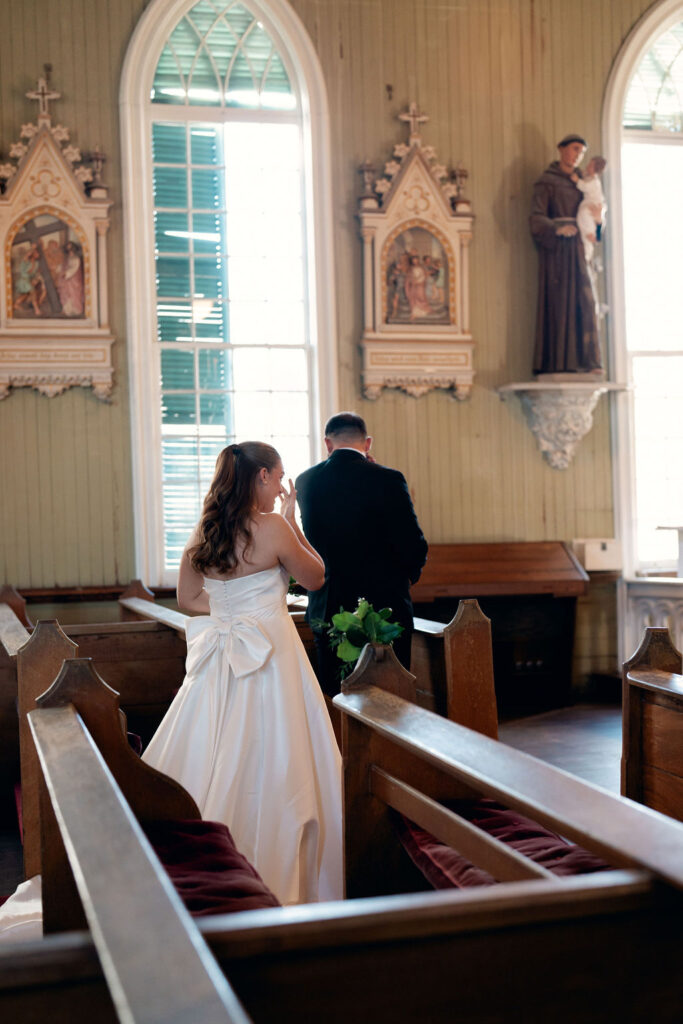 Bride wipes her tears as she reads her vows during their first look before their Real Wedding at Galveston City National Bank Museum