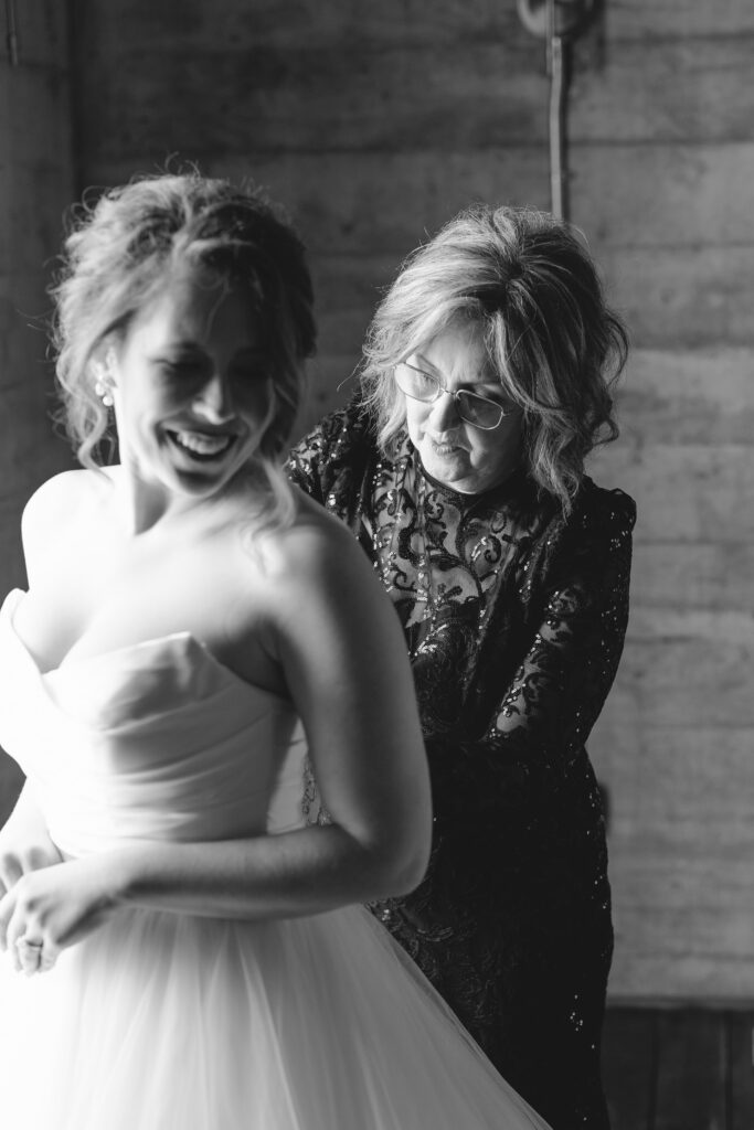 Black and white portrait of bride and her mother smiling together at The Artisan wedding.