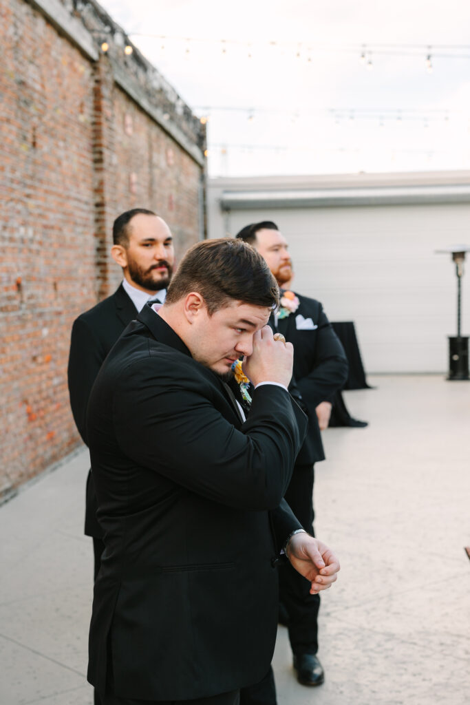 Wedding ceremony in progress at The Artisan with officiant, couple, and wedding party.