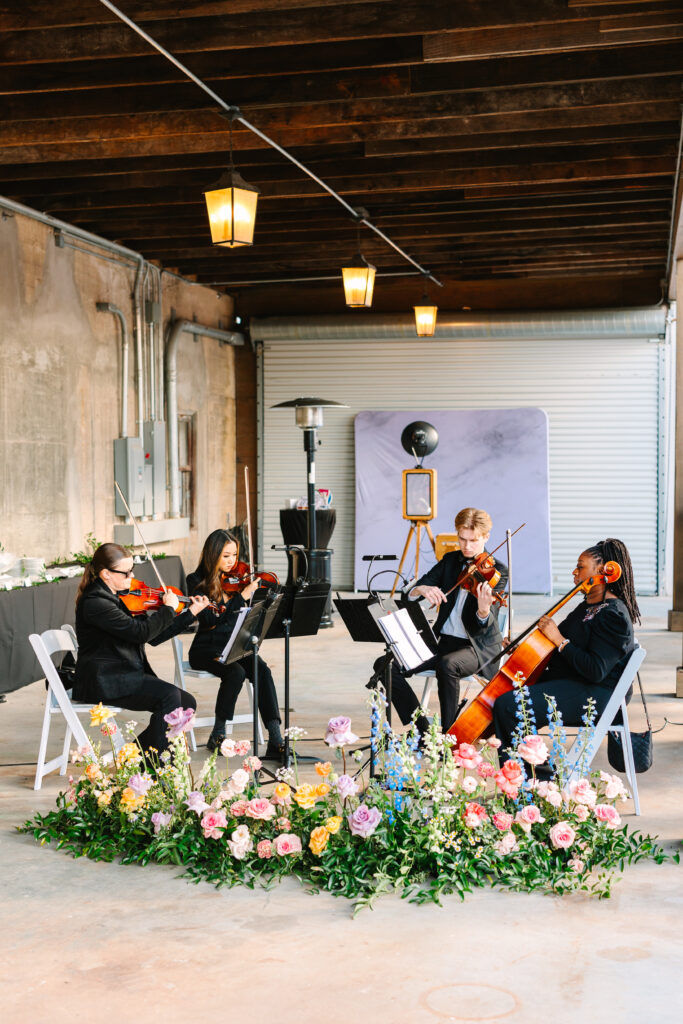 Live musicians performing at the ceremony of a wedding at The Artisan.