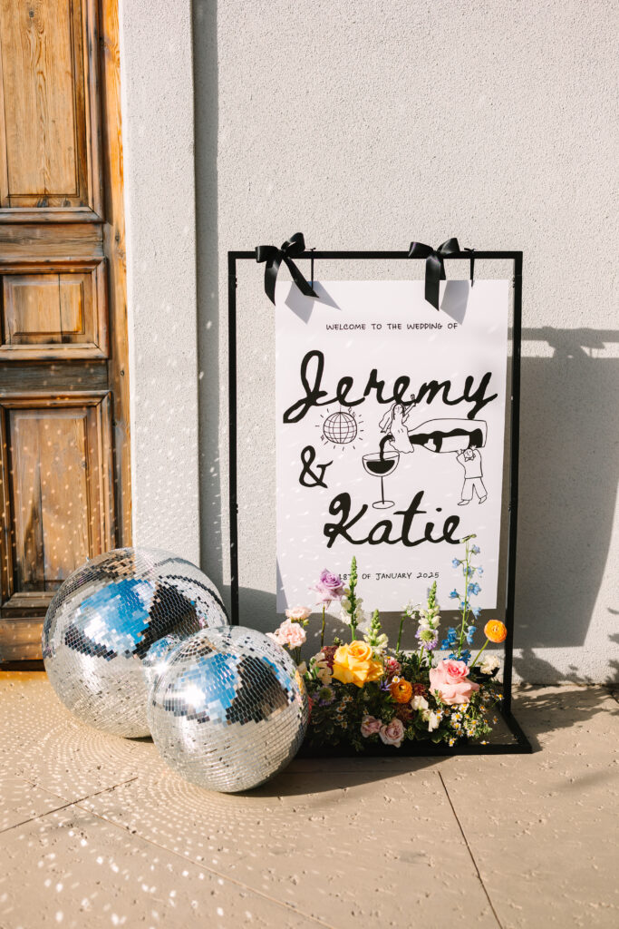 Welcome sign with champagne bottles for a wedding at The Artisan.