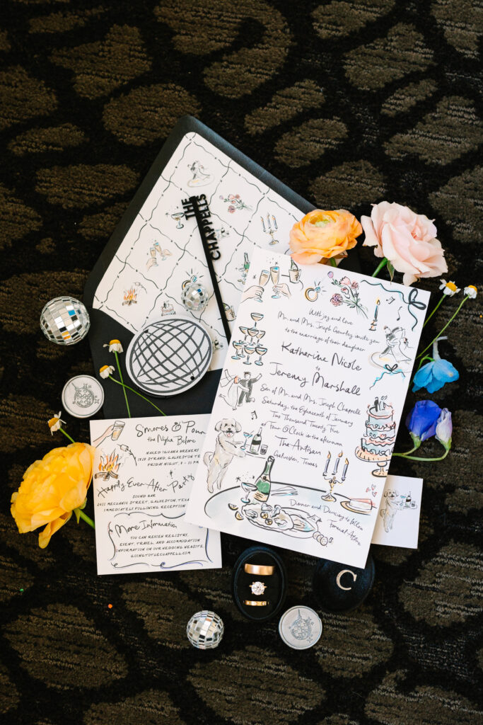 Flat lay of wedding invitation suite, perfume, and jewelry details for a wedding at The Artisan.