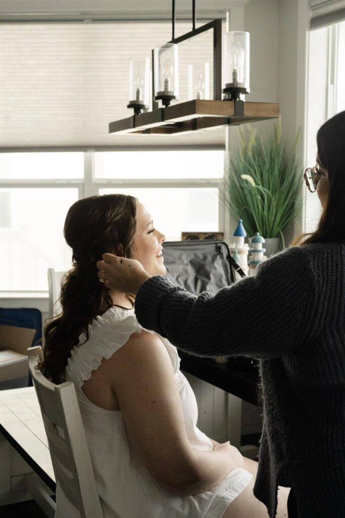 Bride receiving professional hair and makeup styling while getting ready for her wedding at The Bryan Museum.