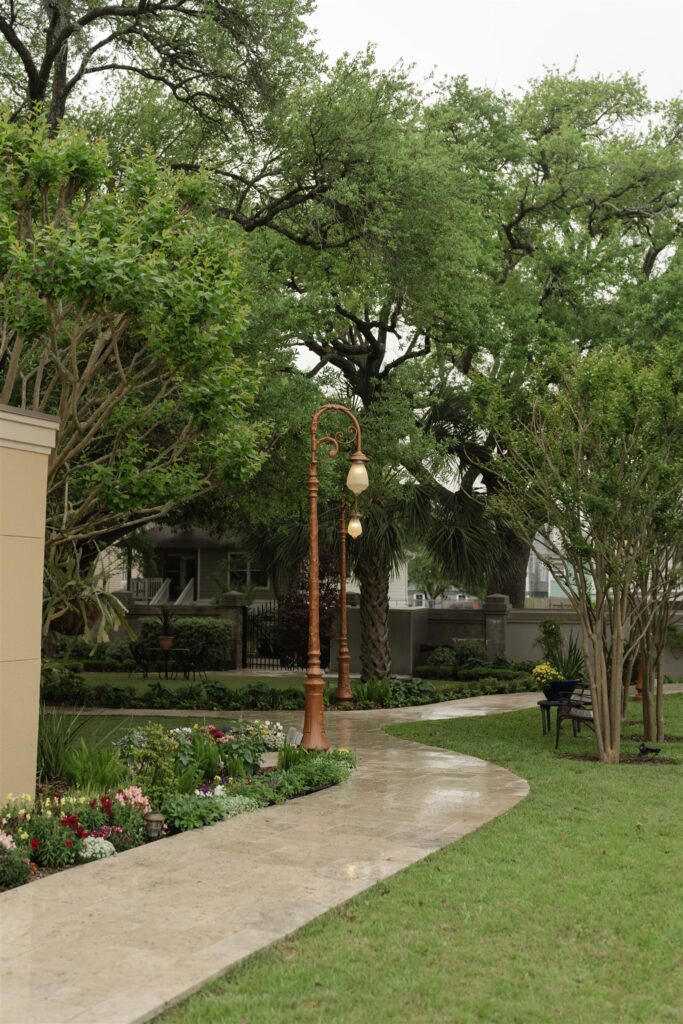 Garden pathway lined with trees and greenery at The Bryan Museum wedding venue.