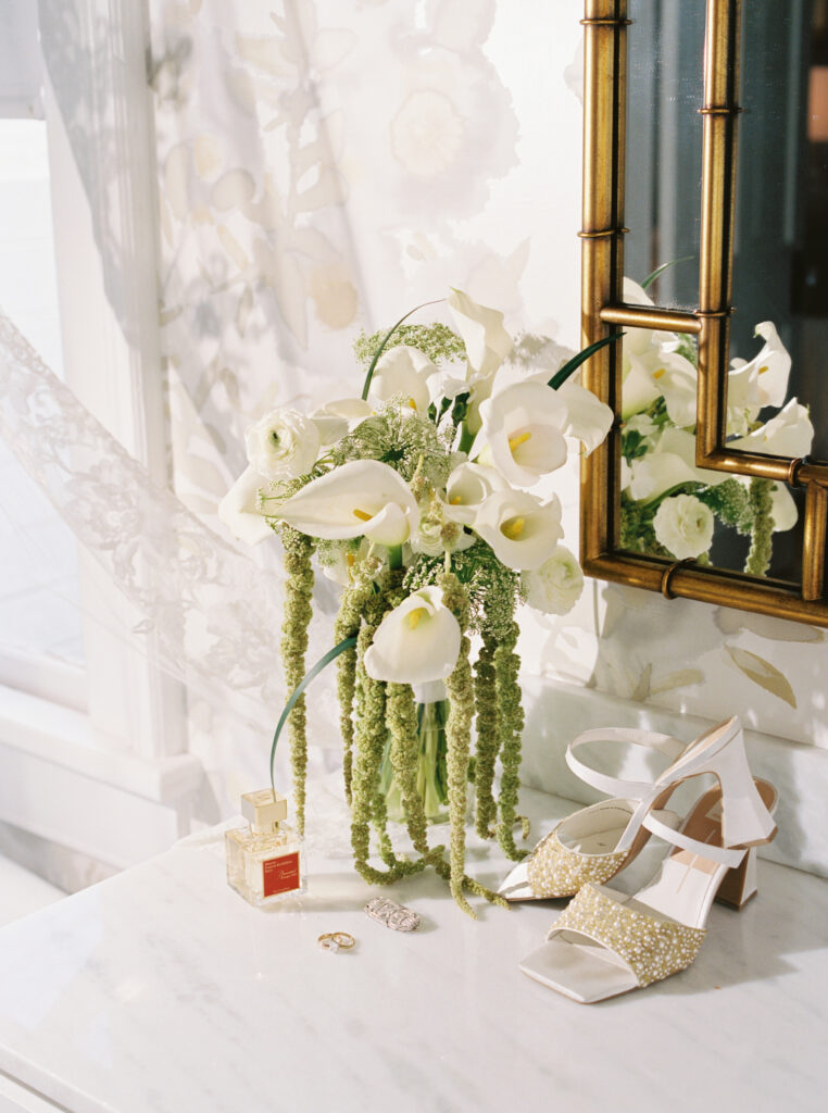 Soft bridal details with perfume, florals, and wedding accessories for a romantic fall wedding at The Bryan Museum.