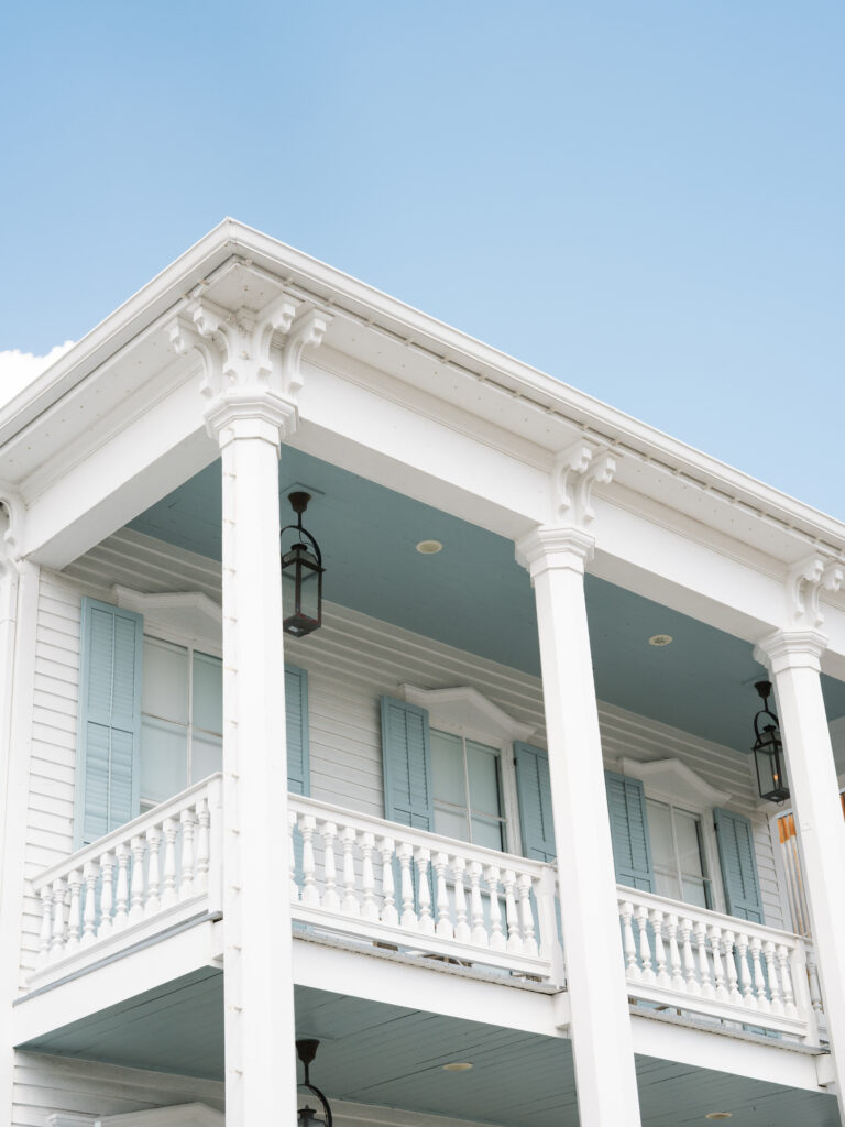 Historic white architecture of the bridal suite at the Bryan Museum in Galveston, Texas during an elegant fall wedding day.